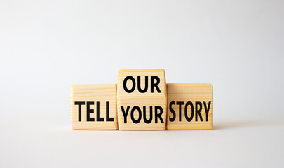 Tell Your or Our story symbol. Wooden cubes with words Tell Our story and Tell Your story. Beautiful white background. Business concept. Copy space