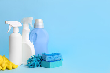 Different cleaning supplies on blue background