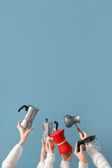 Female hands holding different coffee makers on blue background