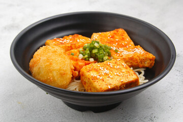 Freshly cooked Japanese food with noodles and fried tofu and fish cake