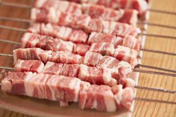 Raw lamb skewers on a plate