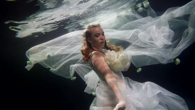bride in wedding dress drowning underwater, slow motion shot, romantic fairytale and dream