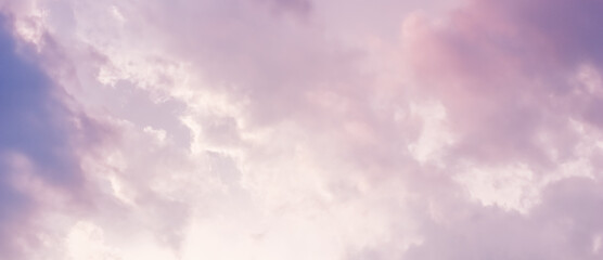 Background of a beautiful pink and pale purple sky with clouds at sunset