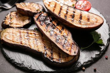 Delicious grilled eggplants on dark background