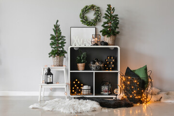 Interior of room with shelving unit, Christmas trees and glowing lights