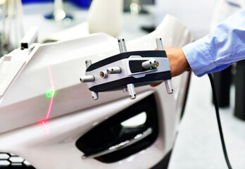 Hand-held 3D laser scanners measure the accuracy of automotive parts. in industrial plants
