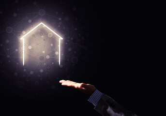 Conceptual image with hand pointing at house or main page icon on dark background