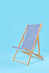 Striped deck chair on blue background