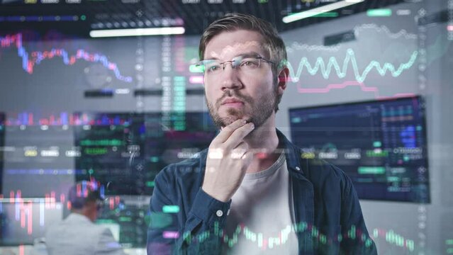 Male trader, businessman watches real-time stocks in modern office. 3D render of virtual cryptocurrency charts and graphs on glass wall. VFX animation. Computers and big digital screens on background.