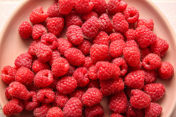 Plate with fresh raspberries, closeup