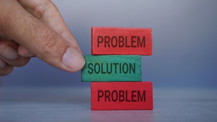 Hand pick wooden cube with text SOLUTION. Problem solving concept
