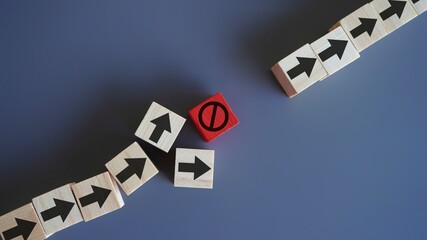 Wooden blocks with arrow and stop icon. Delays and disruptions, stop the process, critical error...