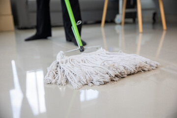 Close up of a woman using a mop to mop the floor cleaning job housewife