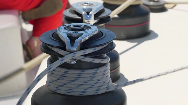 Automatic windlass picking up the rope during the navigation of a sailboat. Close up