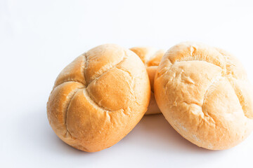 Bread rolls with wheat ears. on a white background. Close-up.