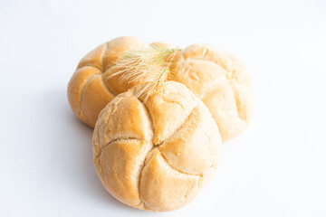 Bread rolls with wheat ears. on a white background. Close-up.