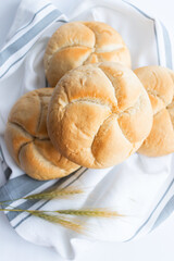 Bread rolls with wheat ears. on a white background. Close-up.