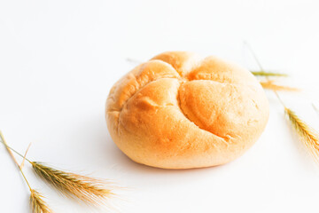 Bread rolls with wheat ears. on a white background. Close-up.