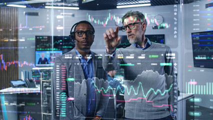 Multiracial financial analysts look on computer generated virtual 3D real-time stocks on glass...