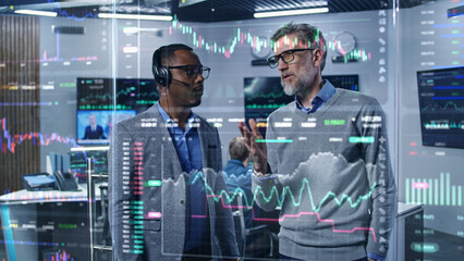 Multiracial financial analysts look on computer generated virtual 3D real-time stocks on glass...