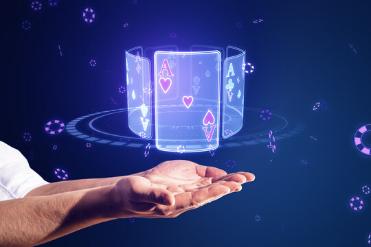 Close up of businessman hands holding creative digital blue cards hologram on dark background. Online casino, poker and digital gaming concept.