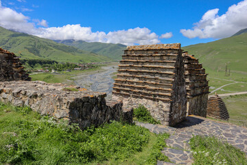 medieval tombs in the city of the dead Dargavs necropolis with picturesque landscape on the background