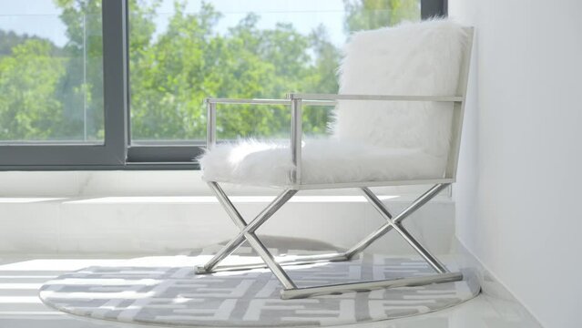 Luxurious fur covered chair near glass window of villa in France,jib shot