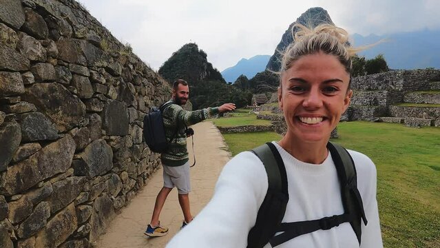 4k woman walking and taking selfie on lost city in Cusco, Machu Pichu city Peru.