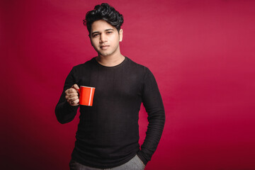 A young man male model posing for a coffee or coffee mug brand. A young man with a confident and...