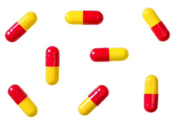 Red and yellow capsules isolated on white background, top view.