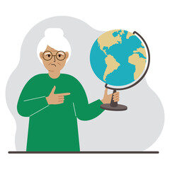 A old woman holds a globe in his hand and points his finger at it. The concept of education, teacher, world conquest, ecology.