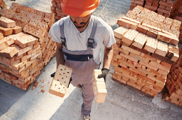 Top view. Handsome Indian man is on the construction site