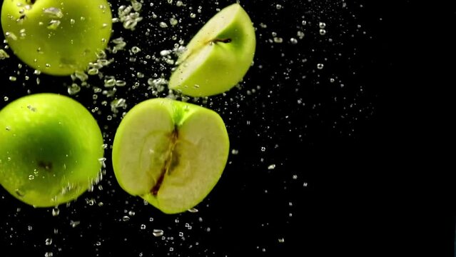 green apple falling into the water, slow motion of fruit in water, slow motion, apple fruit in water 