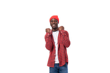 handsome joyful dark-skinned man in a casual plaid shirt of a model appearance with inspiration wants to communicate an idea on a white background with copy space