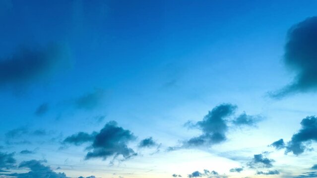 aerial hyperlapse view dark cloud moving in blue sky at blue sunset. .Fluffy white clouds curled into various shapes floating in the blue sky. .clouds that move gracefully across the horizon.
