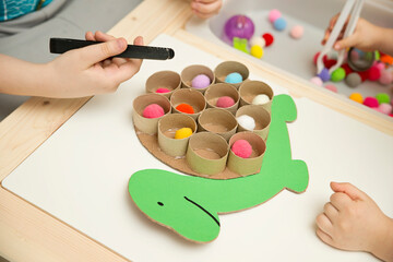 Fototapeta na wymiar Happy turtle. Sorting game for toddlers. Fill cells with pompoms. Early education, learning colors and counting. Montessori thematic implement for preschool and special needs school