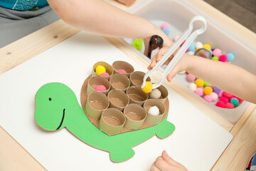 Happy turtle. Sorting game for toddlers. Fill cells with pompoms. Early education, learning colors and counting. Montessori thematic implement for preschool and special needs school
