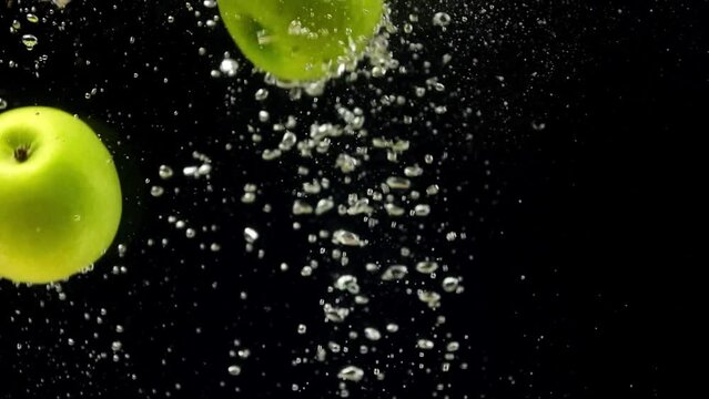 green apple falling into the water, slow motion of fruit in water, slow motion, apple fruits