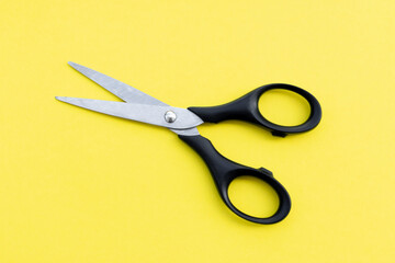 Scissors isolated on yellow  background, after some edits.