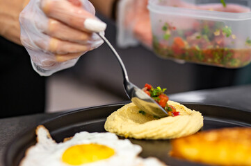 woman chef hand cooking hummus with salad