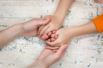 Parent-Child Relationship. Mother's hands holding child's hands