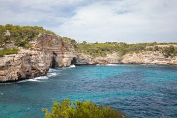 the cliffs near the ocean are rocky and blue and white