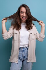 positive cheerful young brunette female adult in casual shirt