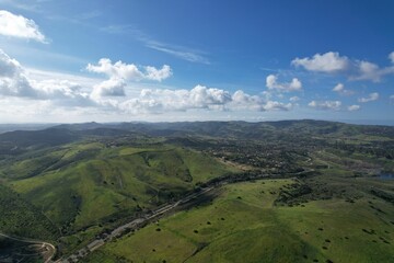 Obraz premium Aerial view of a green field in the hills