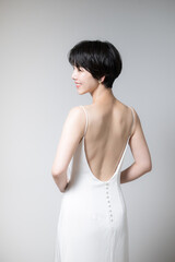 Fototapeta na wymiar Asian women's beautiful backs and shoulder blades Figure of a looking-back beauty looking back Vertical with space for photocopying