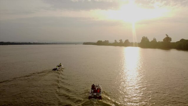 4k drone stock footage flying over Danube following 2 boats in Romania