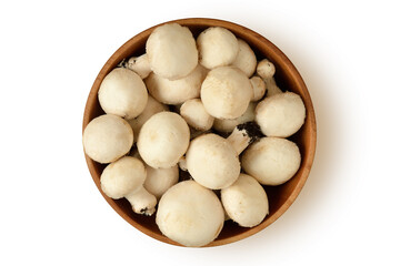 Whole champignon mushrooms in wooden bowl on white background