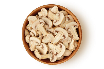 Sliced champignon mushrooms in wooden bowl on white background