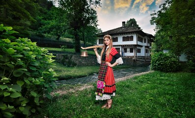 Bulgarian woman wearing a traditional costume in the Ethno village of Etar in Gabrovo, Bulgaria