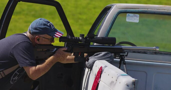 Marksman Aiming And Firing Rifle From The Rear Of A Vehicle As Firing Point During PRS Match In Leach, Oklahoma. medium shot